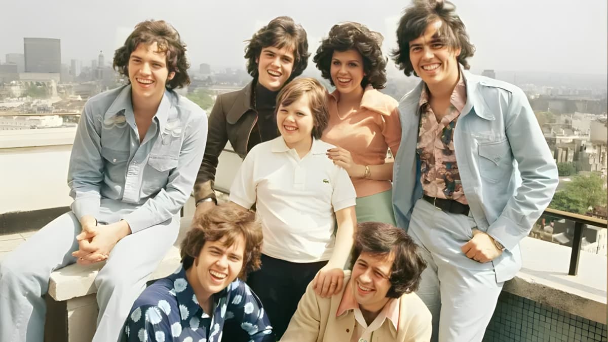 The Osmond family smiling and posing together.