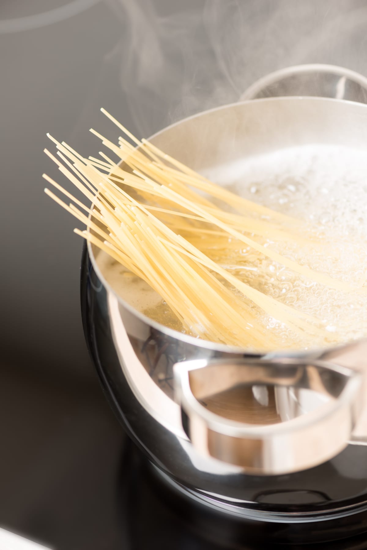 Angel hair pasta in a pan cooking