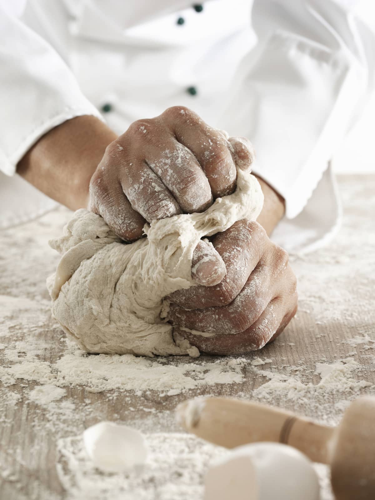 Woman kneading dough.