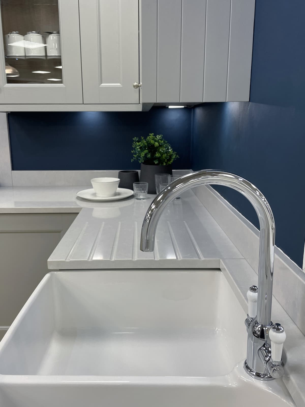 A sink in a blue colored kitchen