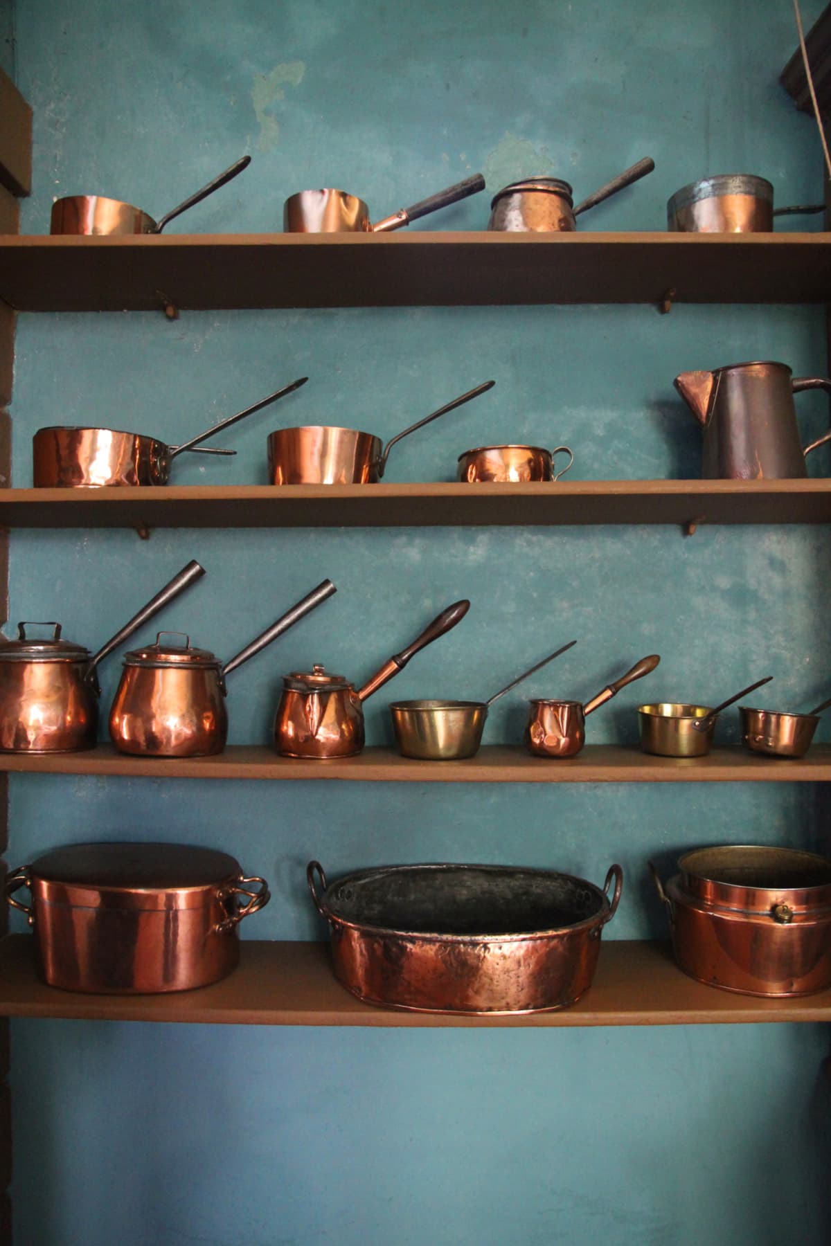 Old copper pots on shelves