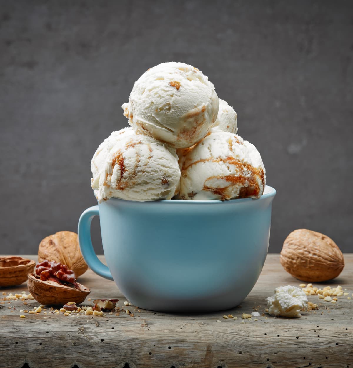 cup of walnut and maple syrup ice cream on wooden table