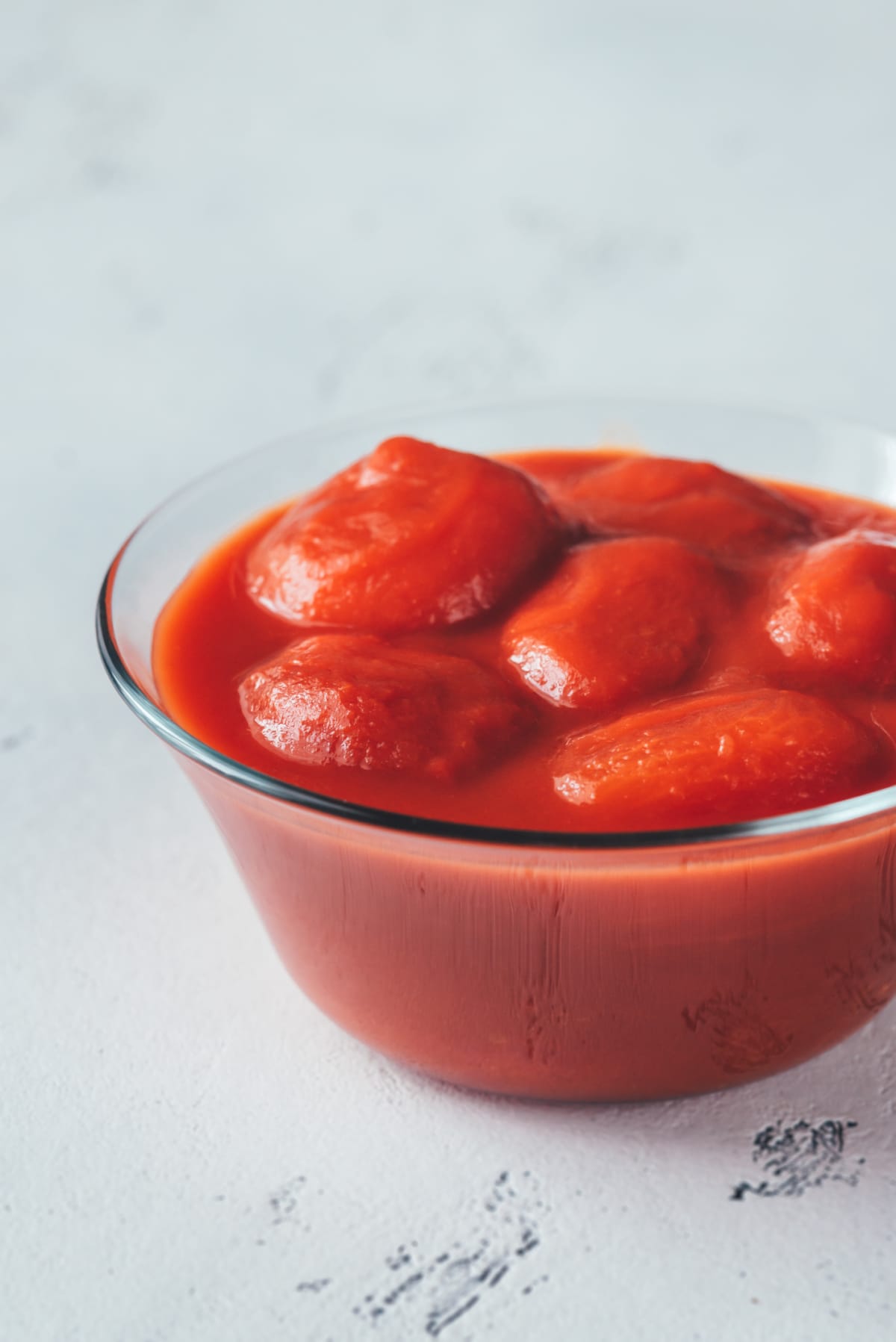 Canned tomatoes in a clear bowl