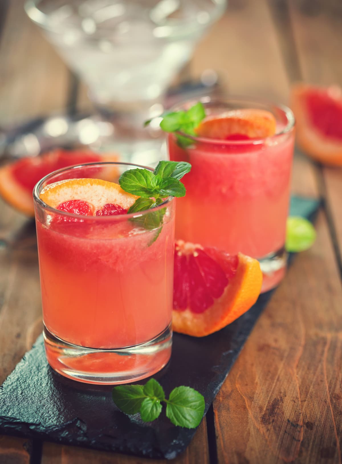 Tequila palomas cocktail with grapefruit and mint garnish