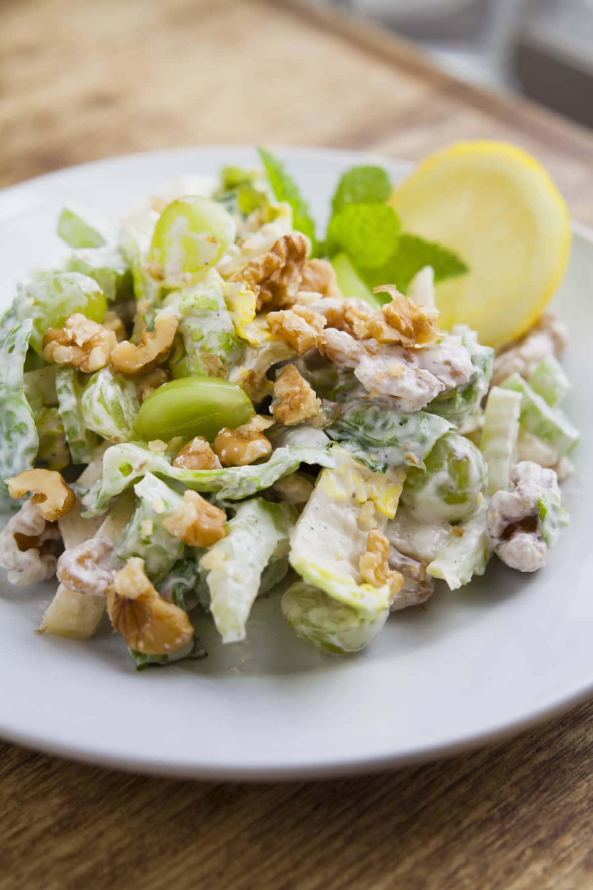 A Waldorf salad is a fruit and nut salad generally made of fresh apples, celery, grapes and walnuts, dressed in mayonnaise or yoghurt sauce.