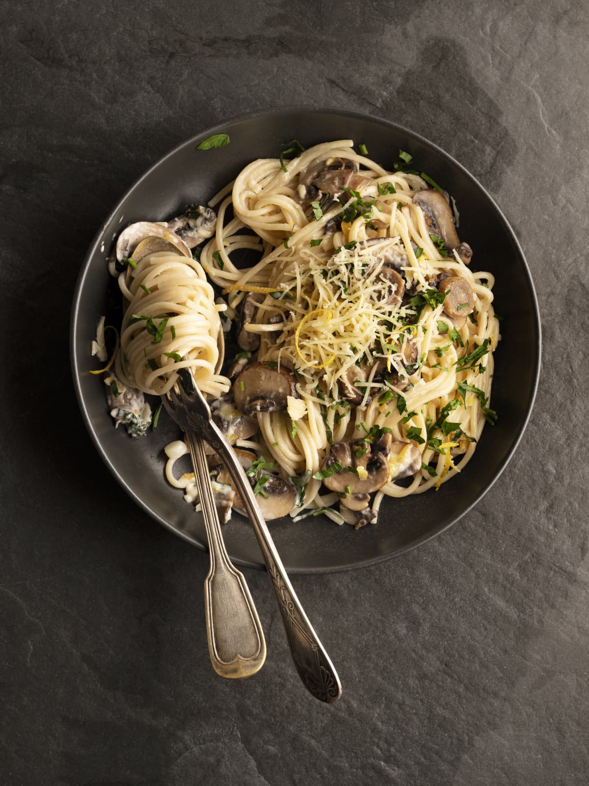 Pasta with forks and cheese and mushrooms
