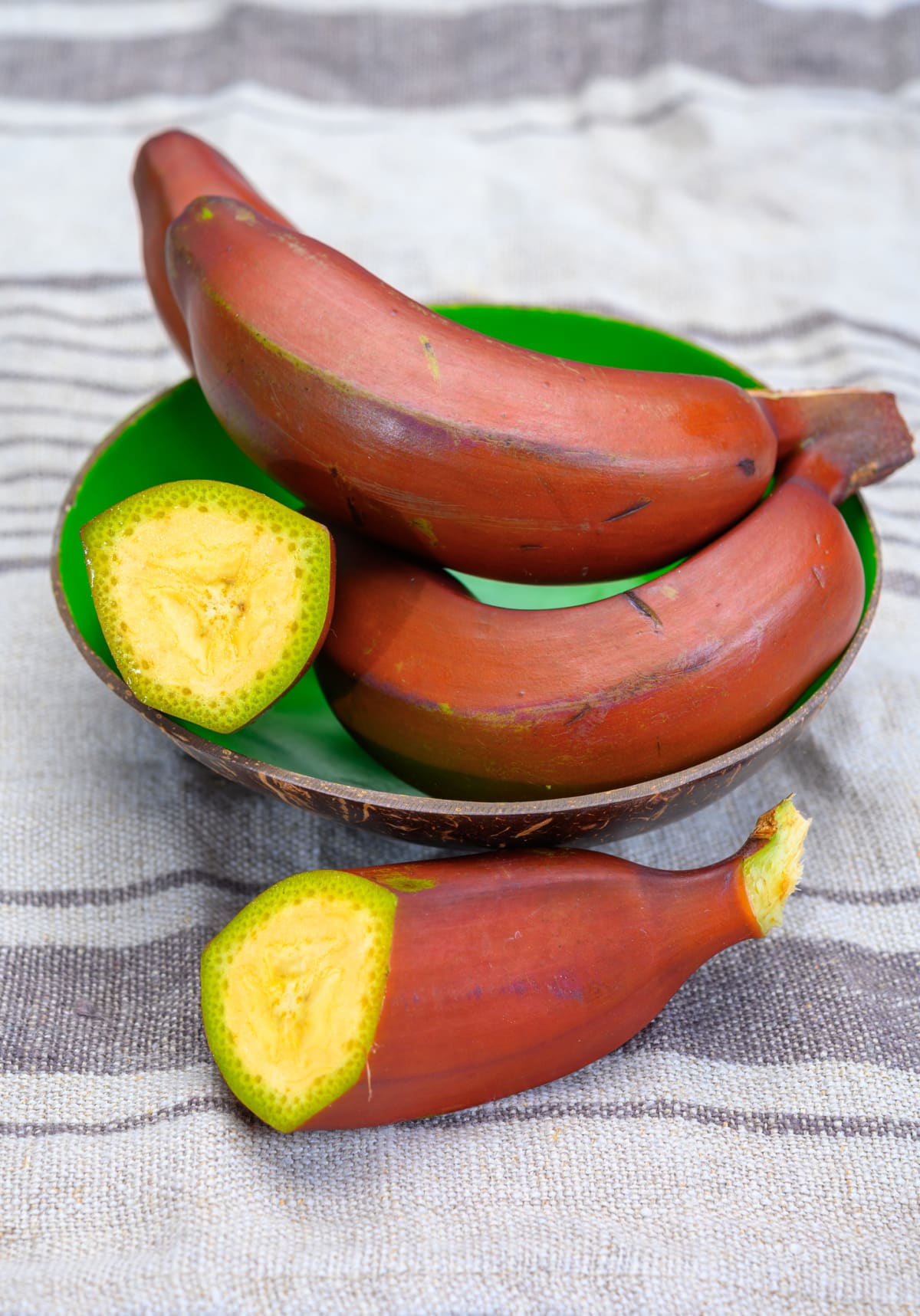 Bunch of ripe red bananas close up in bowl