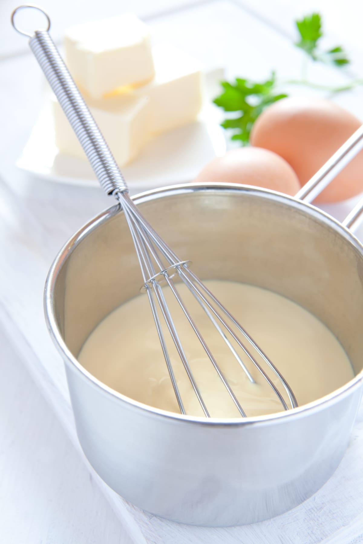Pot of sauce with whisk