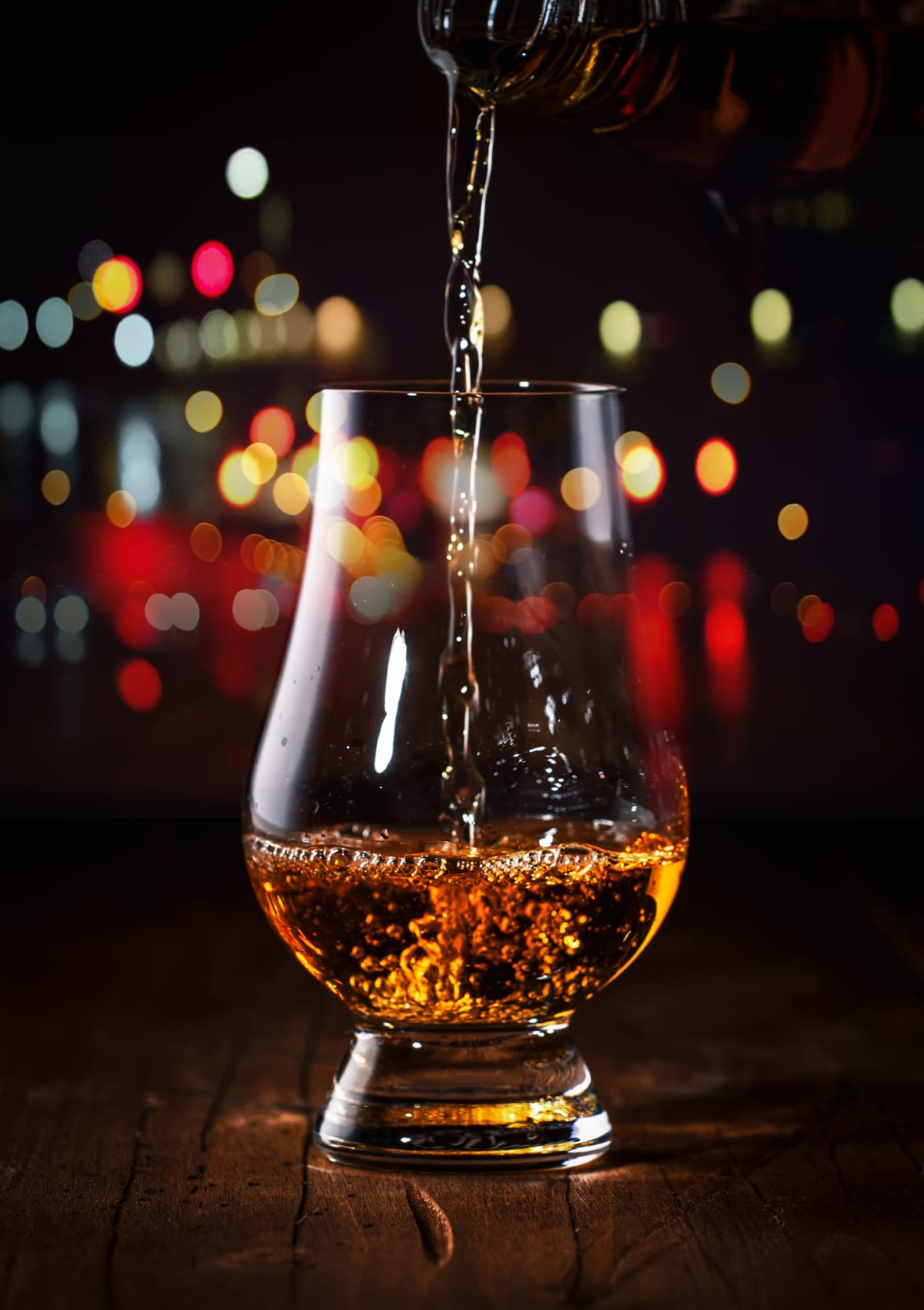 Whiskey pouring into Glencairn glass