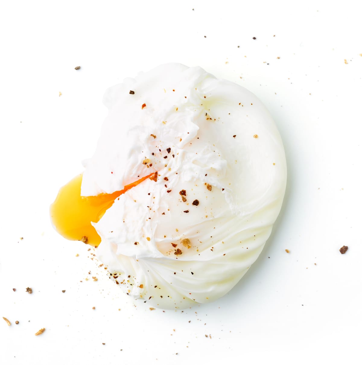 A poached egg with black pepper flakes