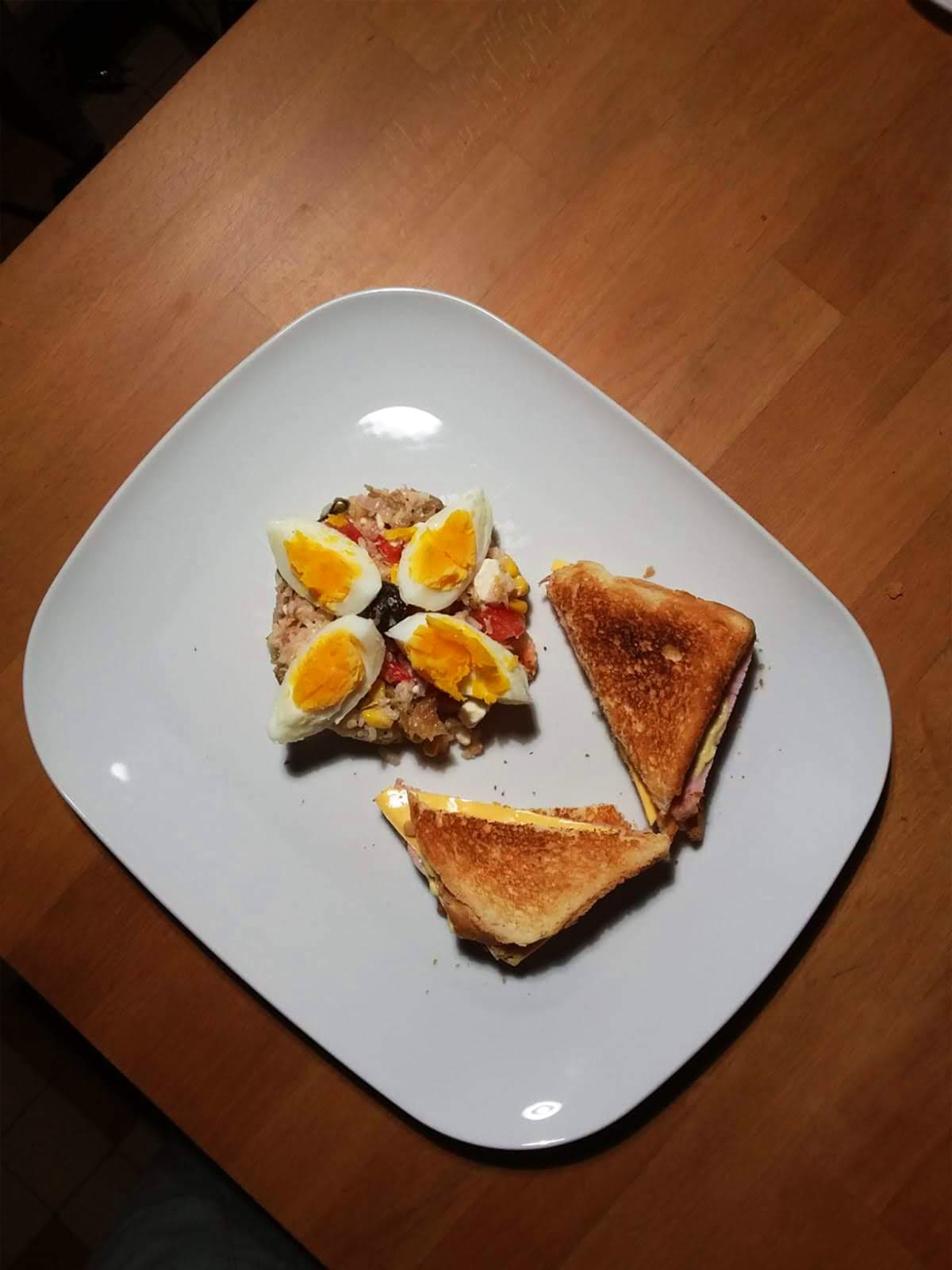 Homemade club sandwich with tuna rice salad and egg topping