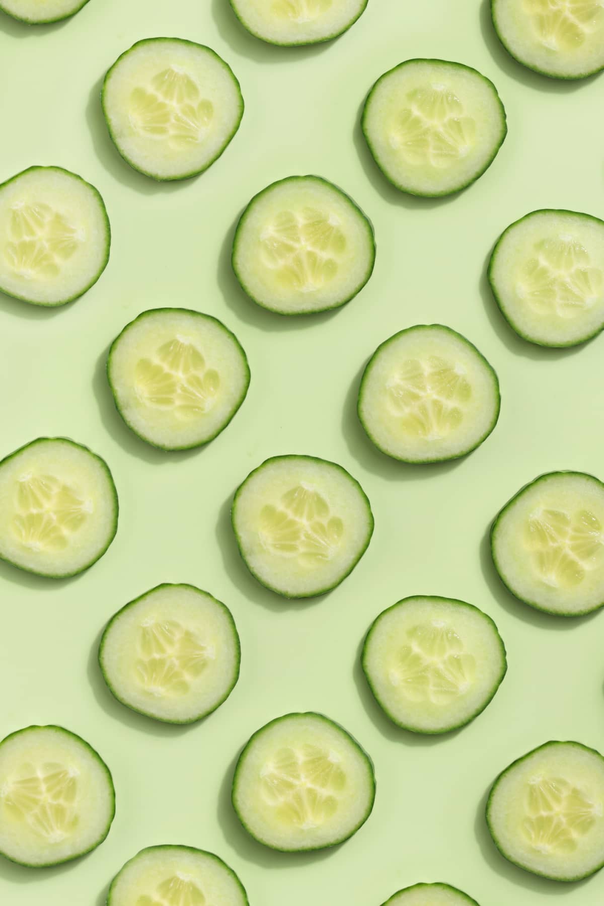 Cucumber rounds on a light green background