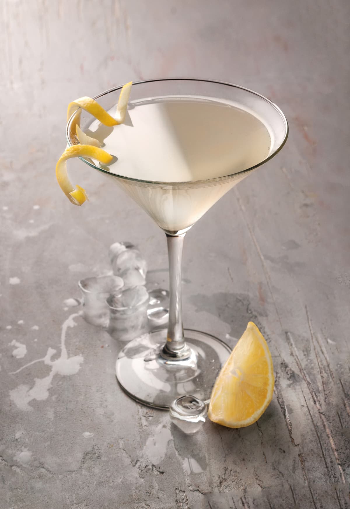 Martini glass of French 75 cocktail with lemon twist
