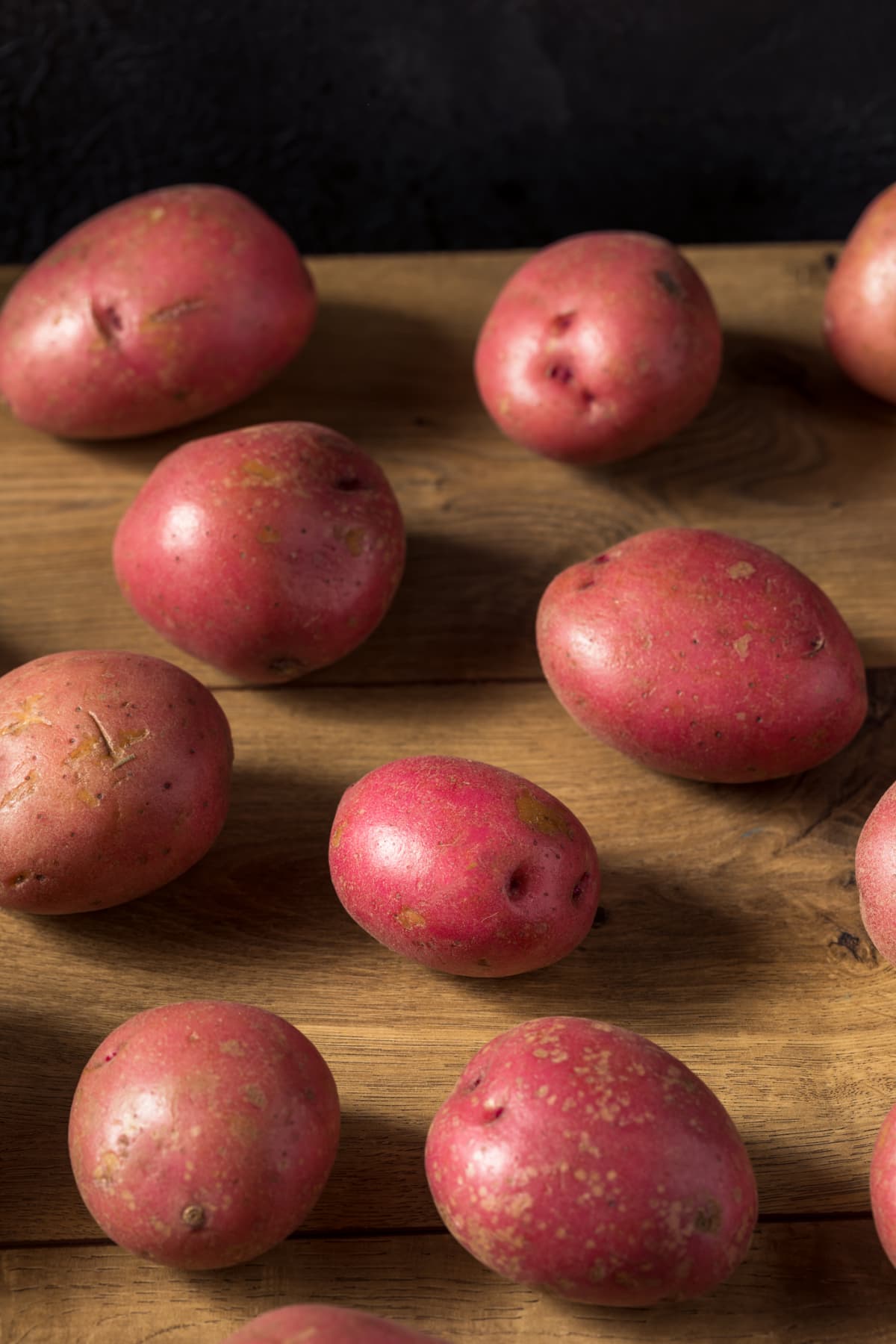 Red potatoes on a wooden background