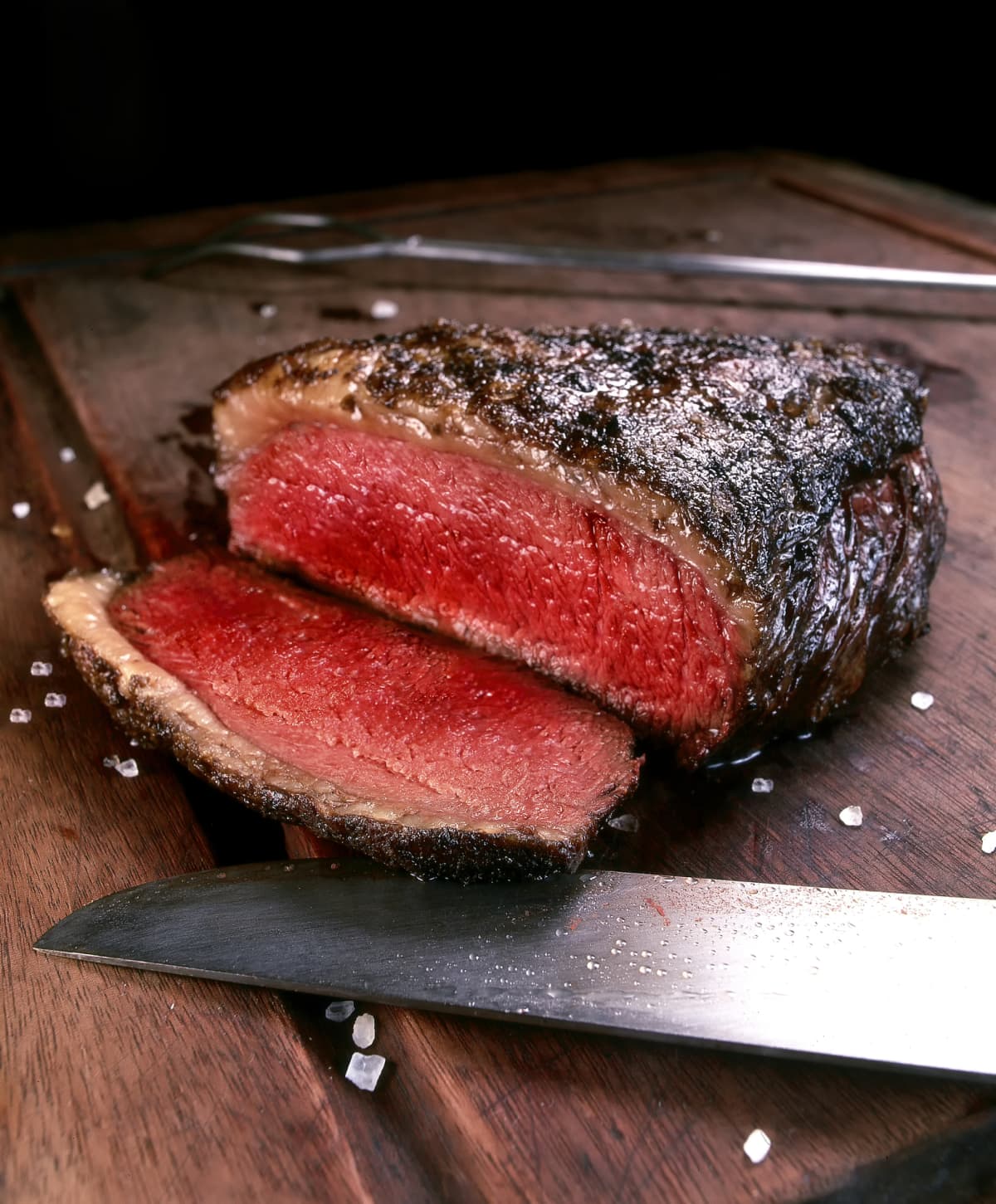 Rump steak being cut with a steak knife.
