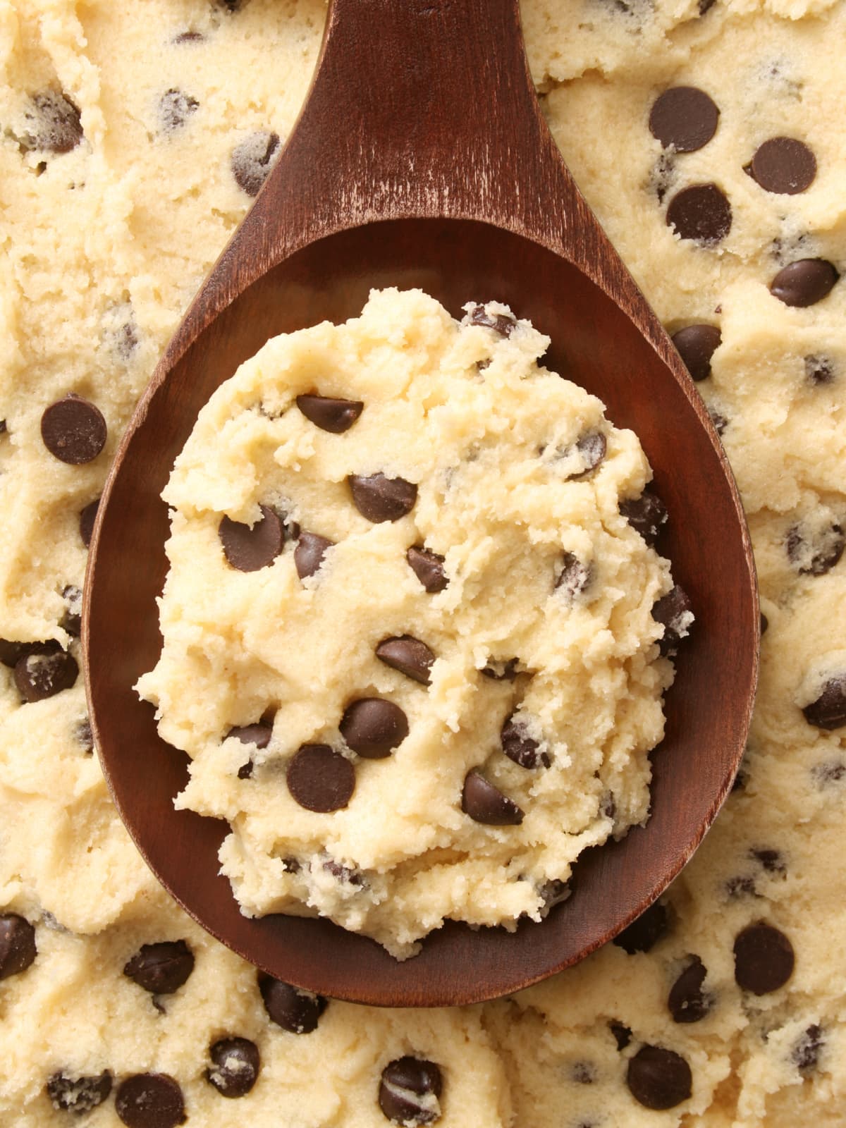 A scoop of cookie dough on a wooden spoon