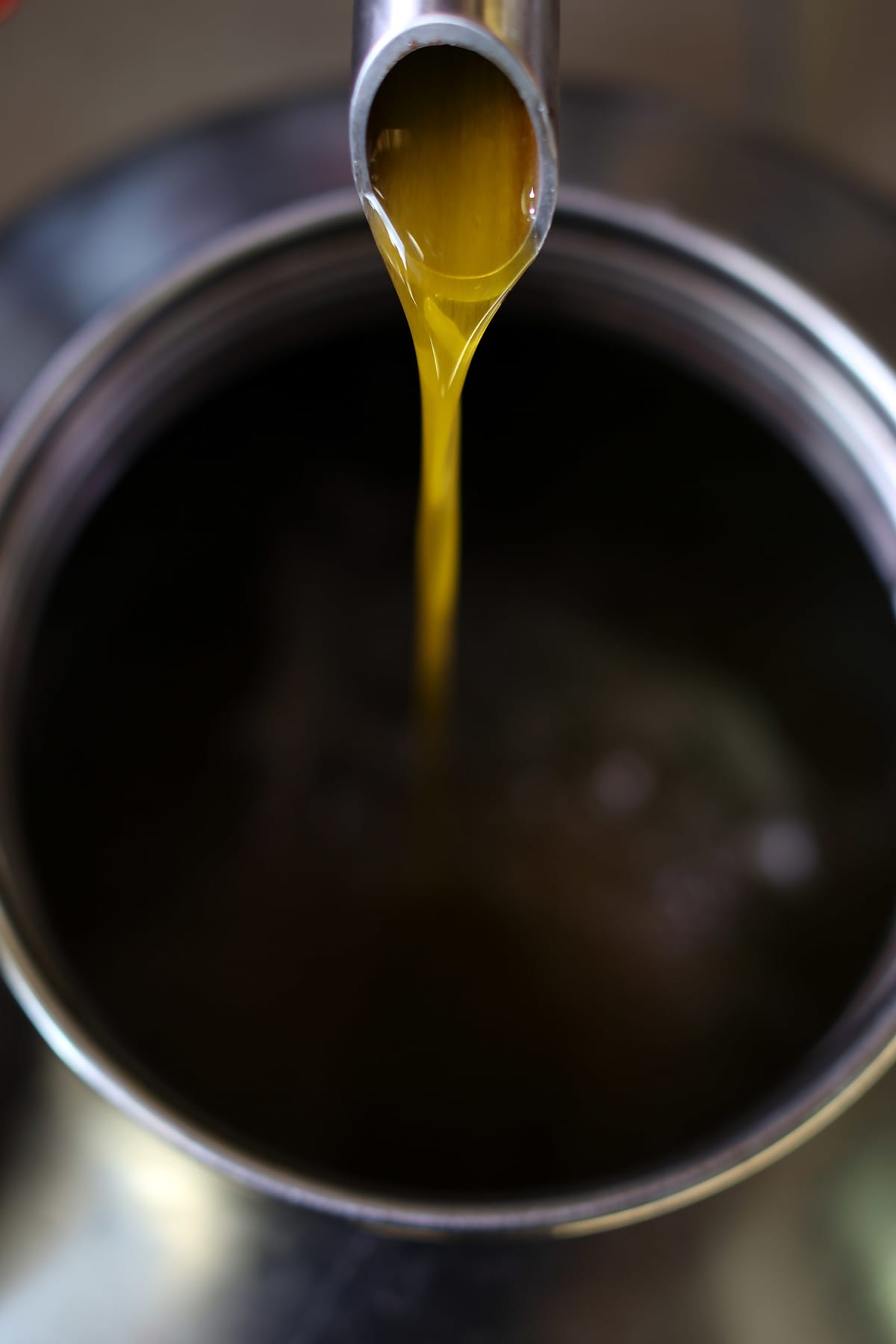 Processed olive oil pouring from a spout