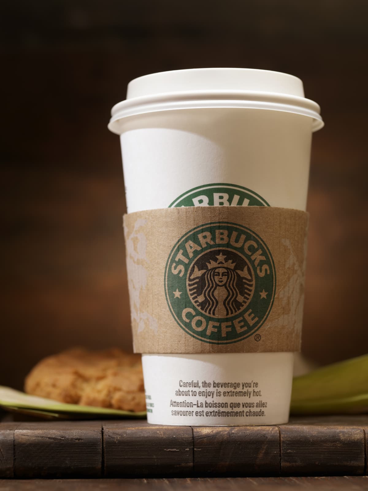 Starbucks grande coffee cup on wood surface