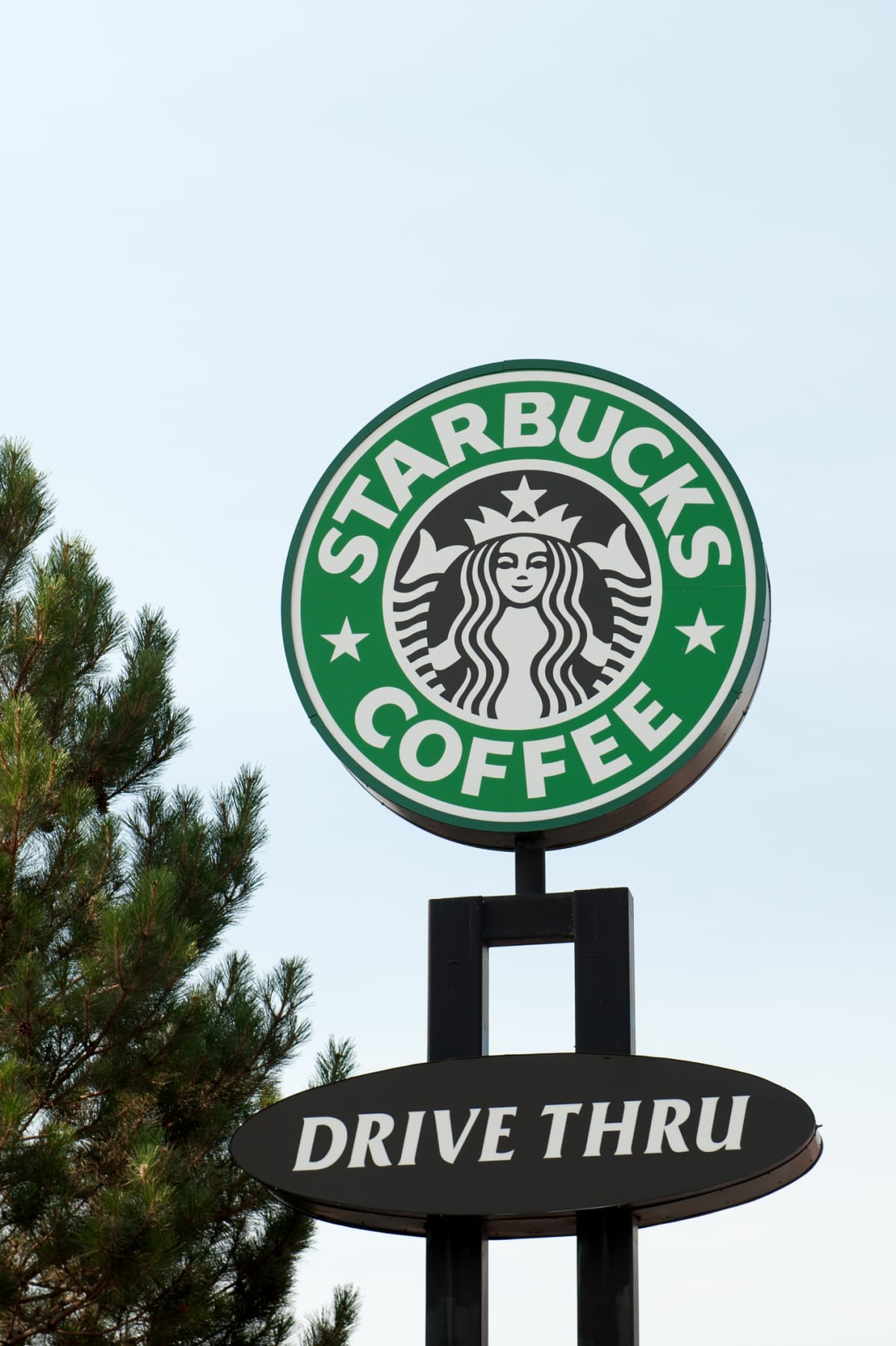 Albuquerqe, New Mexico, USA - July 2, 2011: Drive Thru Starbucks Coffee Sign with Logo in  North East Albuquerque. Starbucks Corporation is an international coffee and coffeehouse chain based in Seattle, Washington. Starbucks sells drip brewed coffee, espresso-based hot drinks, other hot and cold drinks, coffee beans, salads, hot and cold sandwiches and panini, and pastries.