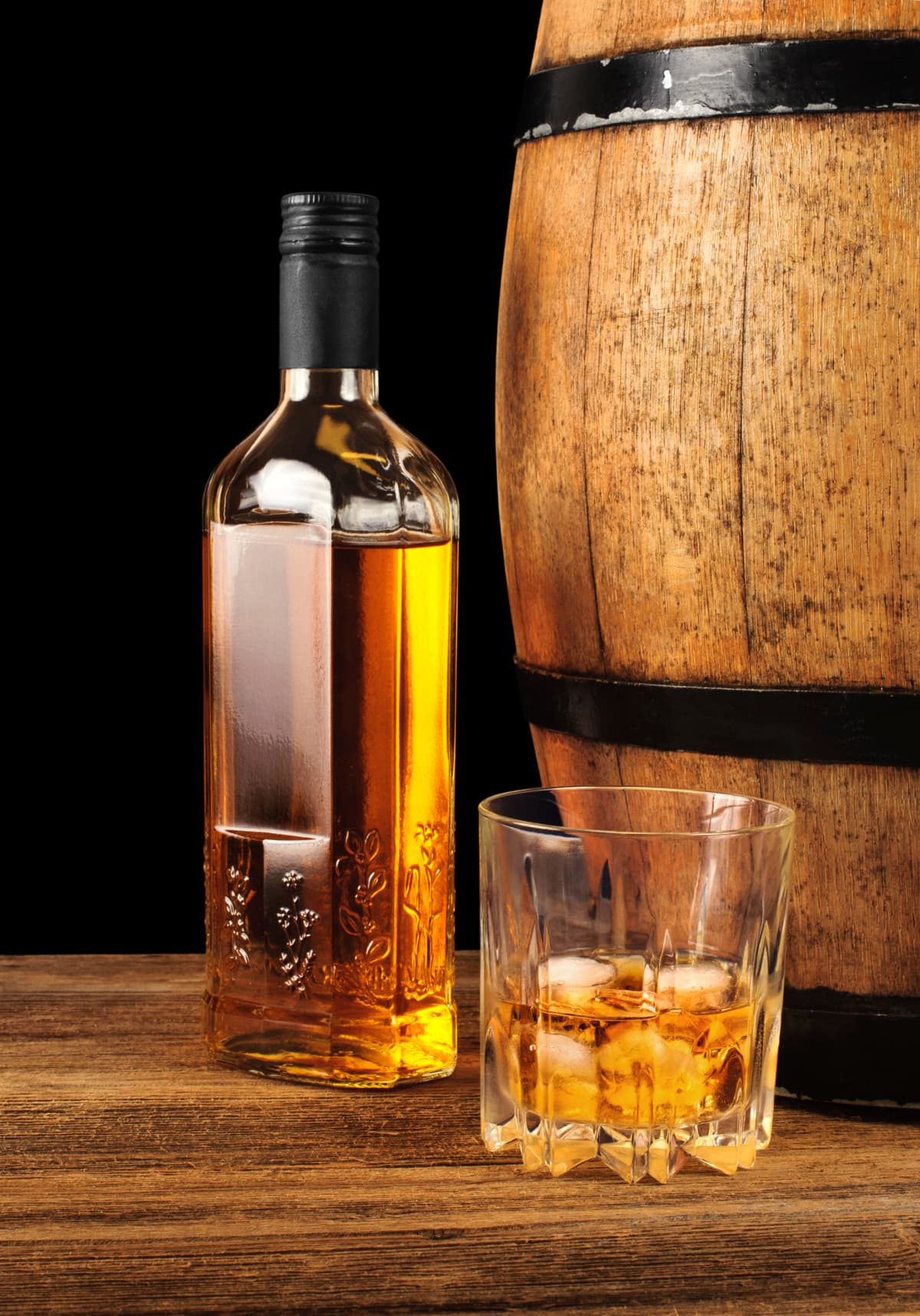 Whiskey bottle and glass with oak barrel