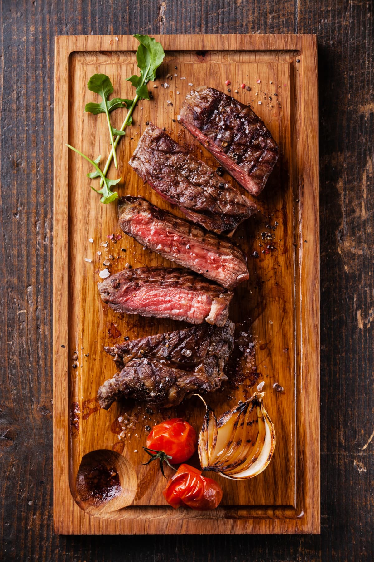 A piece of cut up steak on a cutting board