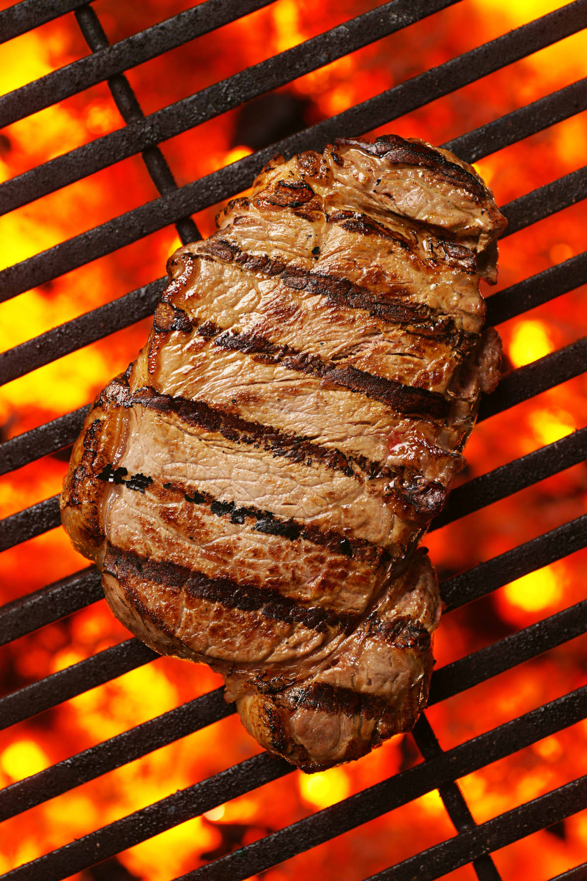 Steak sizzling on a grill