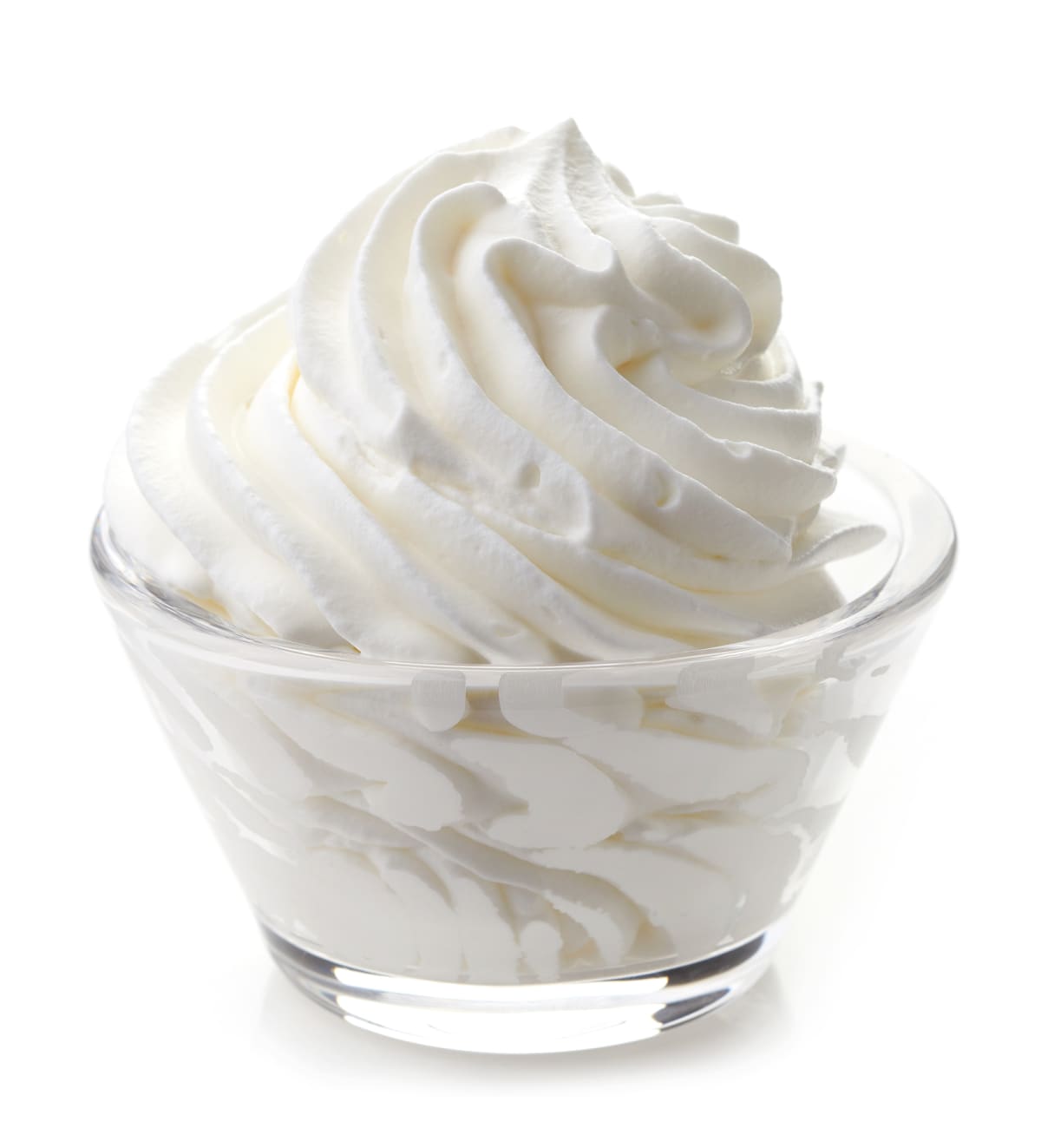 Glass bowl of whipped cream isolated on a white background