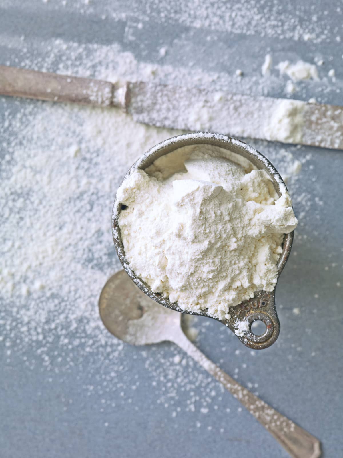 Bowl of flour with flour scattered on counter