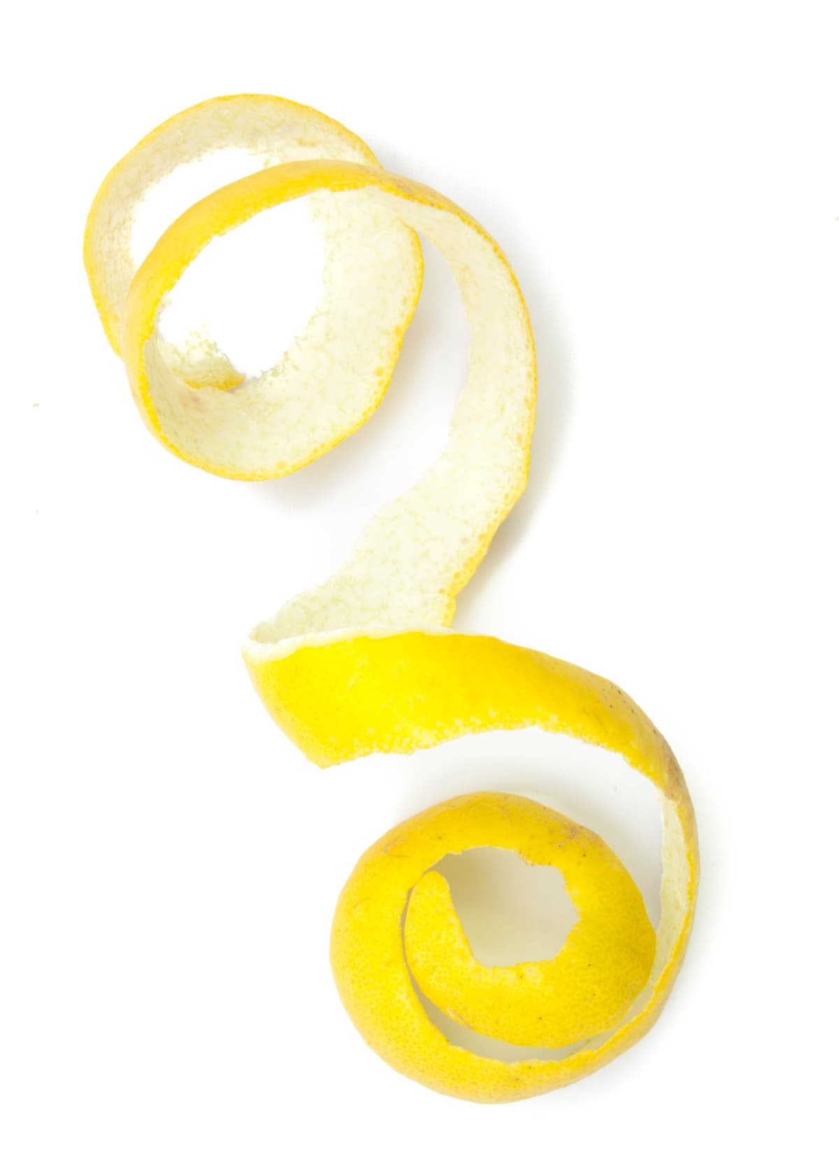 Peeled lemon zest on a white background