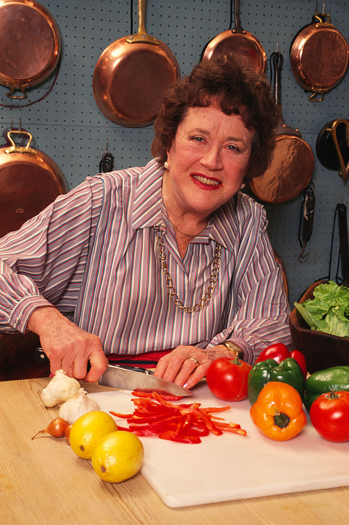 Julia Child cutting vegetables in kitchen