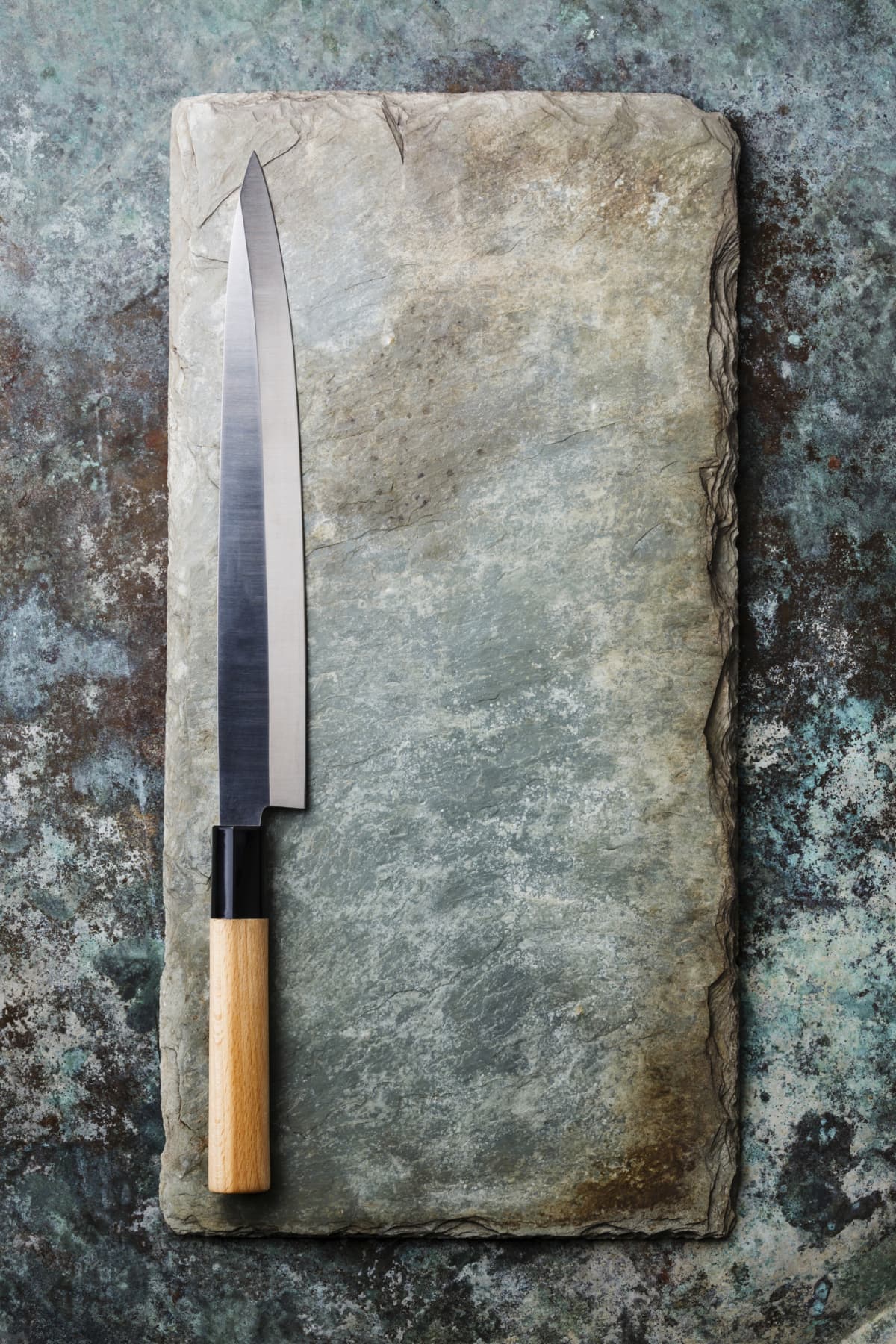 A knife atop a sharpening stone