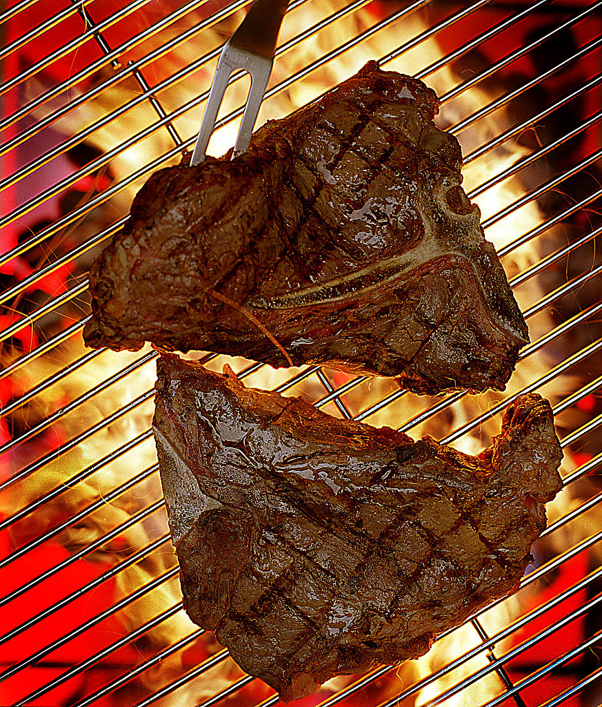 Steaks on a BBQ grill.