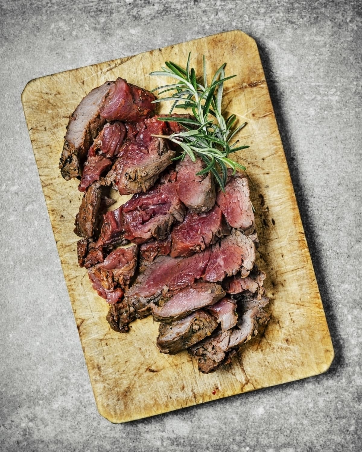 Cut steak on a plate on a wooden cutting board background