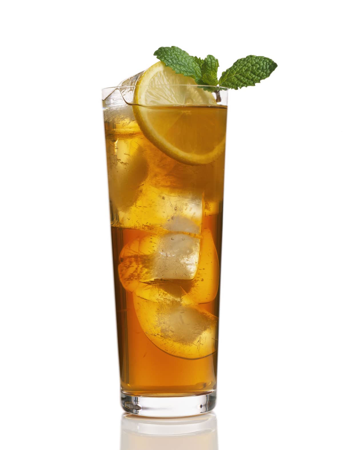 Glass of iced tea with lemon slice and green garnish on white background