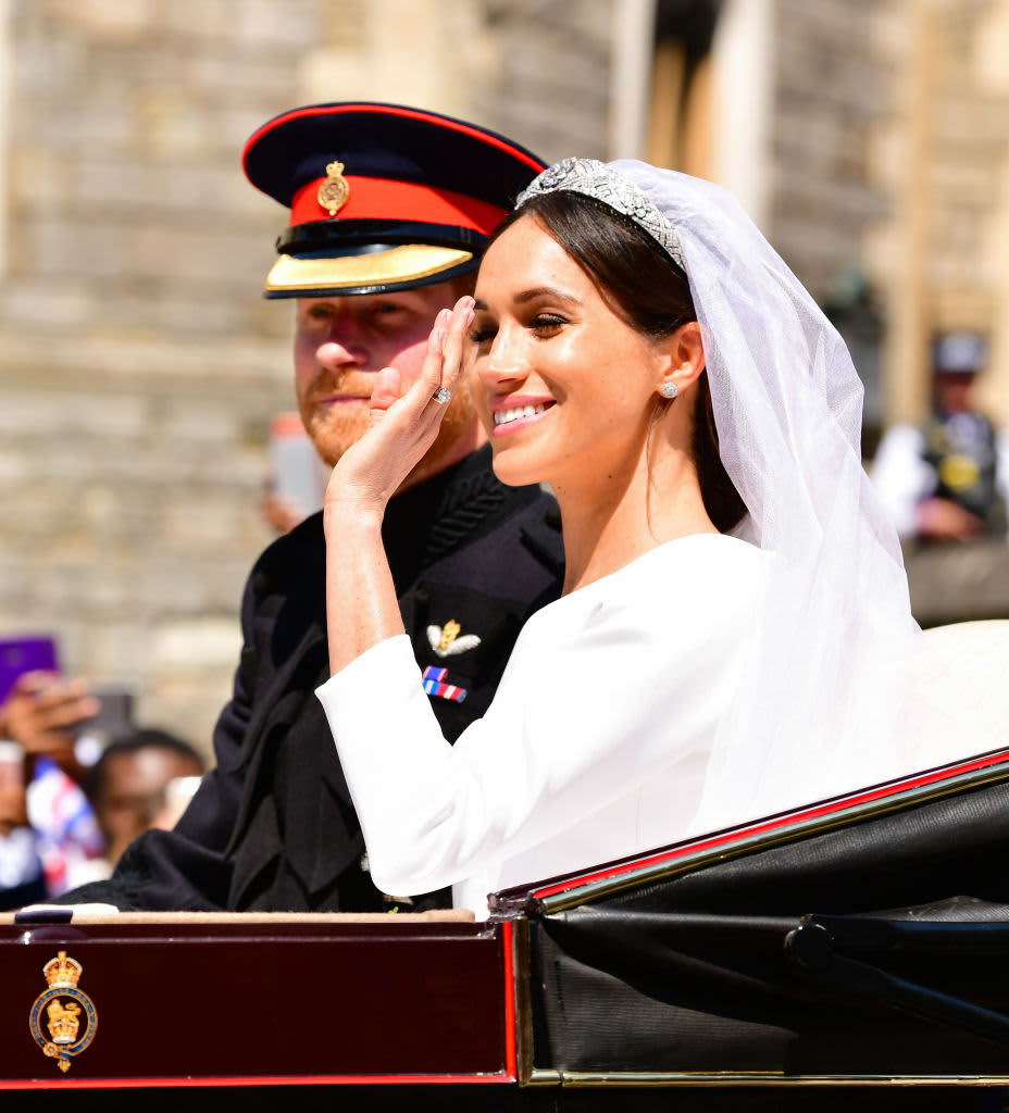 WINDSOR, ENGLAND - MAY 19:  Prince Harry, Duke of Sussex and Meghan, Duchess of Sussex leave Windsor Castle  in the Ascot Landau carriage during the procession after getting married at St George's Chapel, Windsor Castle on May 19, 2018 in Windsor, England. Prince Henry Charles Albert David of Wales marries Ms. Meghan Markle in a service at St George's Chapel inside the grounds of Windsor Castle. Among the guests were 2200 members of the public, the royal family and Ms. Markle's Mother Doria Ragland.  (Photo by James Devaney/GC Images)