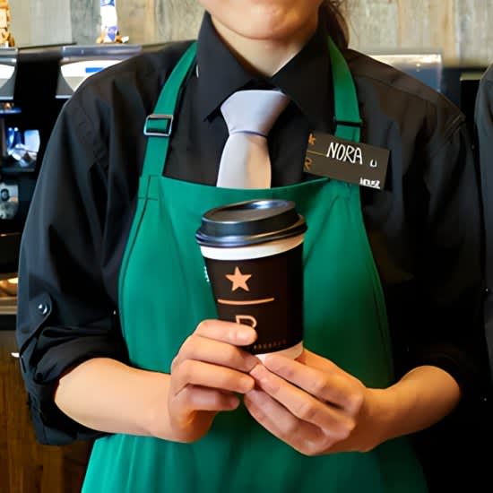 Starbucks barista holding drink cup