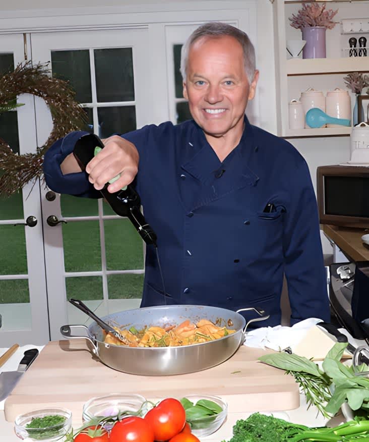 Wolfgang Puck cooking in kitchen