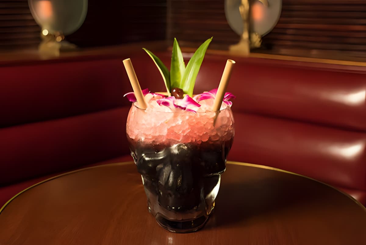 Black cocktail in skull-shaped glass