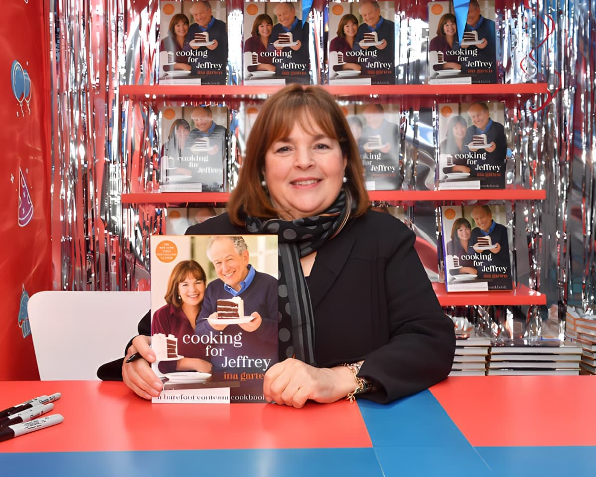 Ina Garten poses with one of her cookbooks