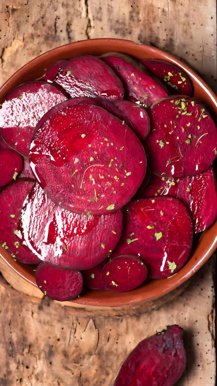 Sliced cooked beets in a wooden bowl