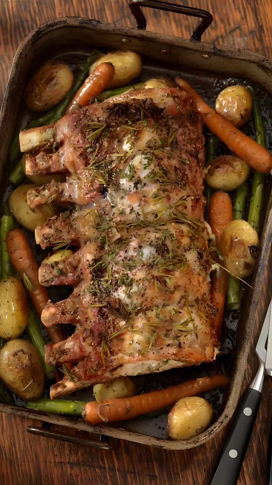 Roasted pork in pan on a bed of vegetables