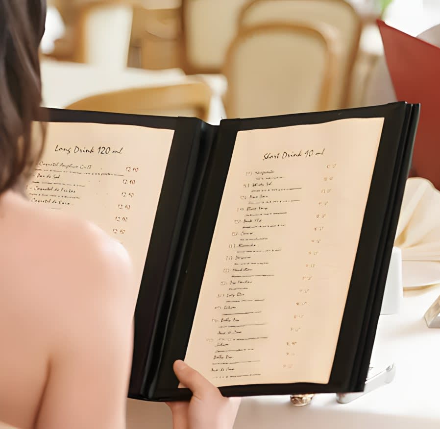 Hand holding restaurant menu