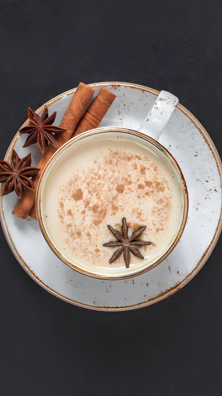 Mug of chai with cinnamon and star anise pod