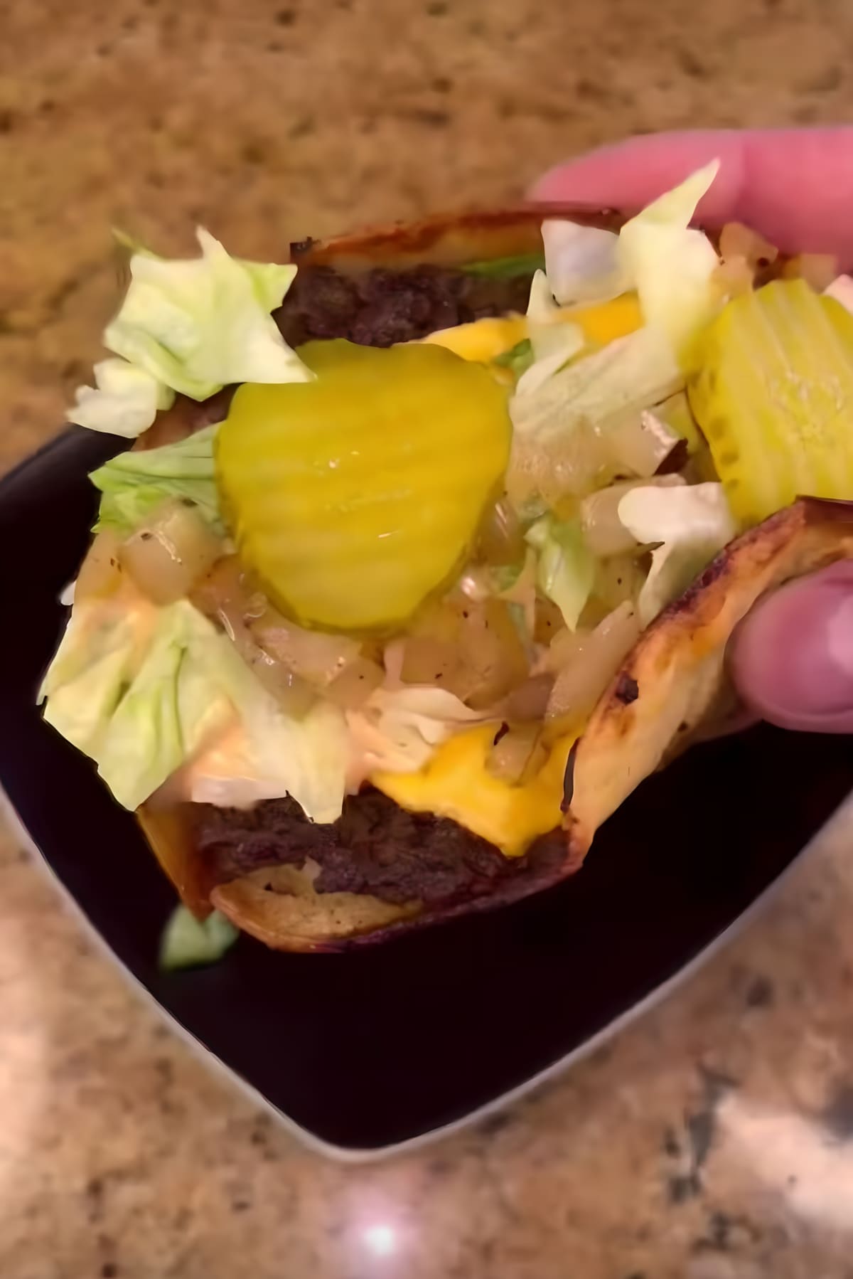 Smashburger taco with lettuce, pickles, and sauce