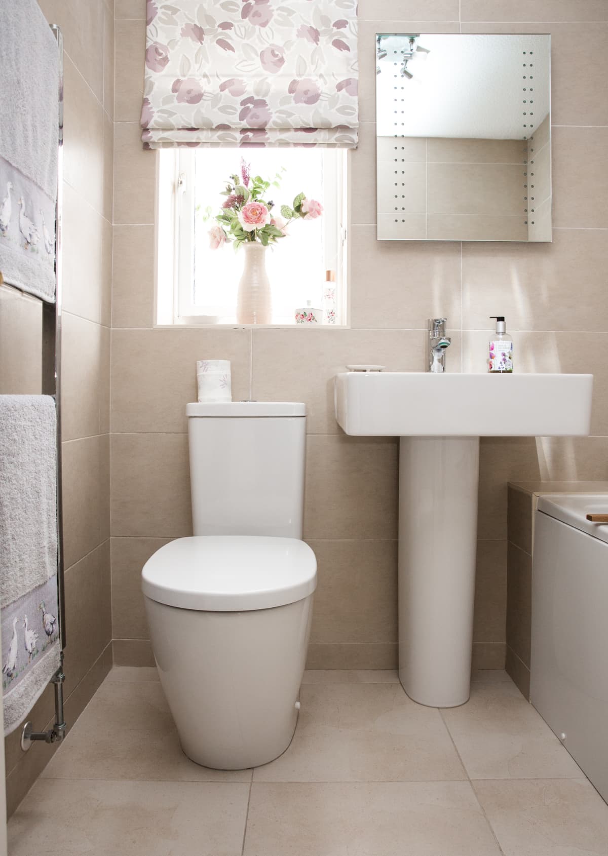 Contemporary tiled bathroom with white bathroom suite including toilet and sink basin