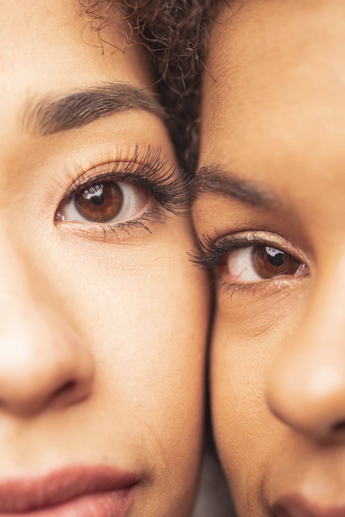 Close up shot of a beautiful African American woman and an Asian Woman.
