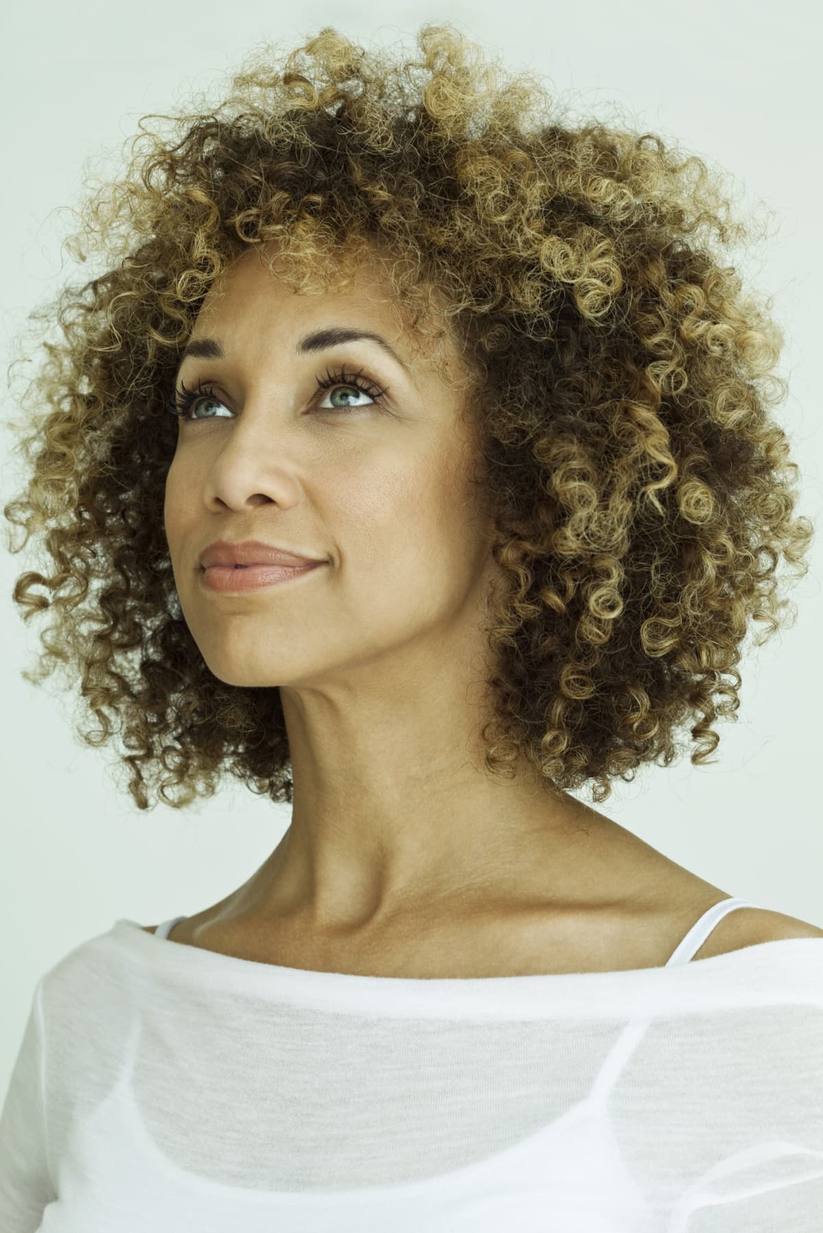 woman with curly, highlighted hair