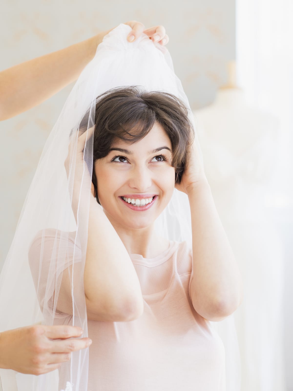A bride tries on a veil.