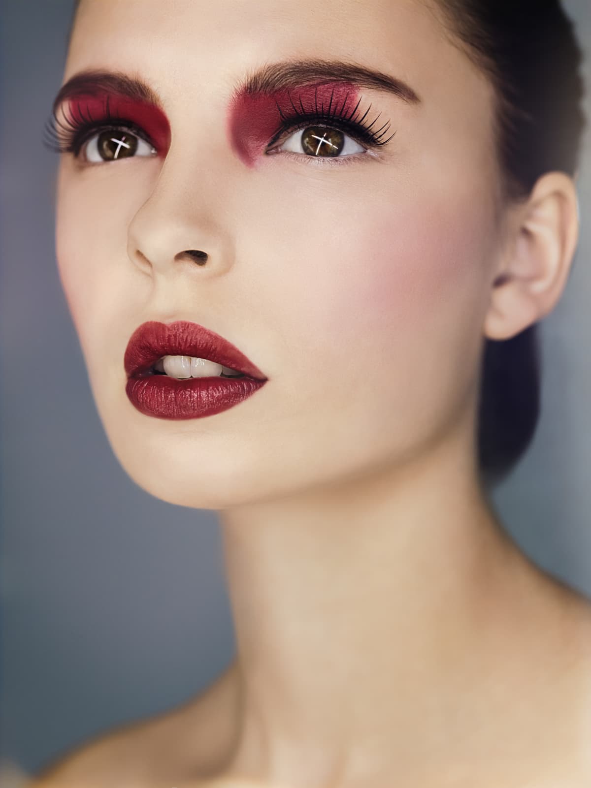 Beautiful woman with red eyeshadow and lipstick