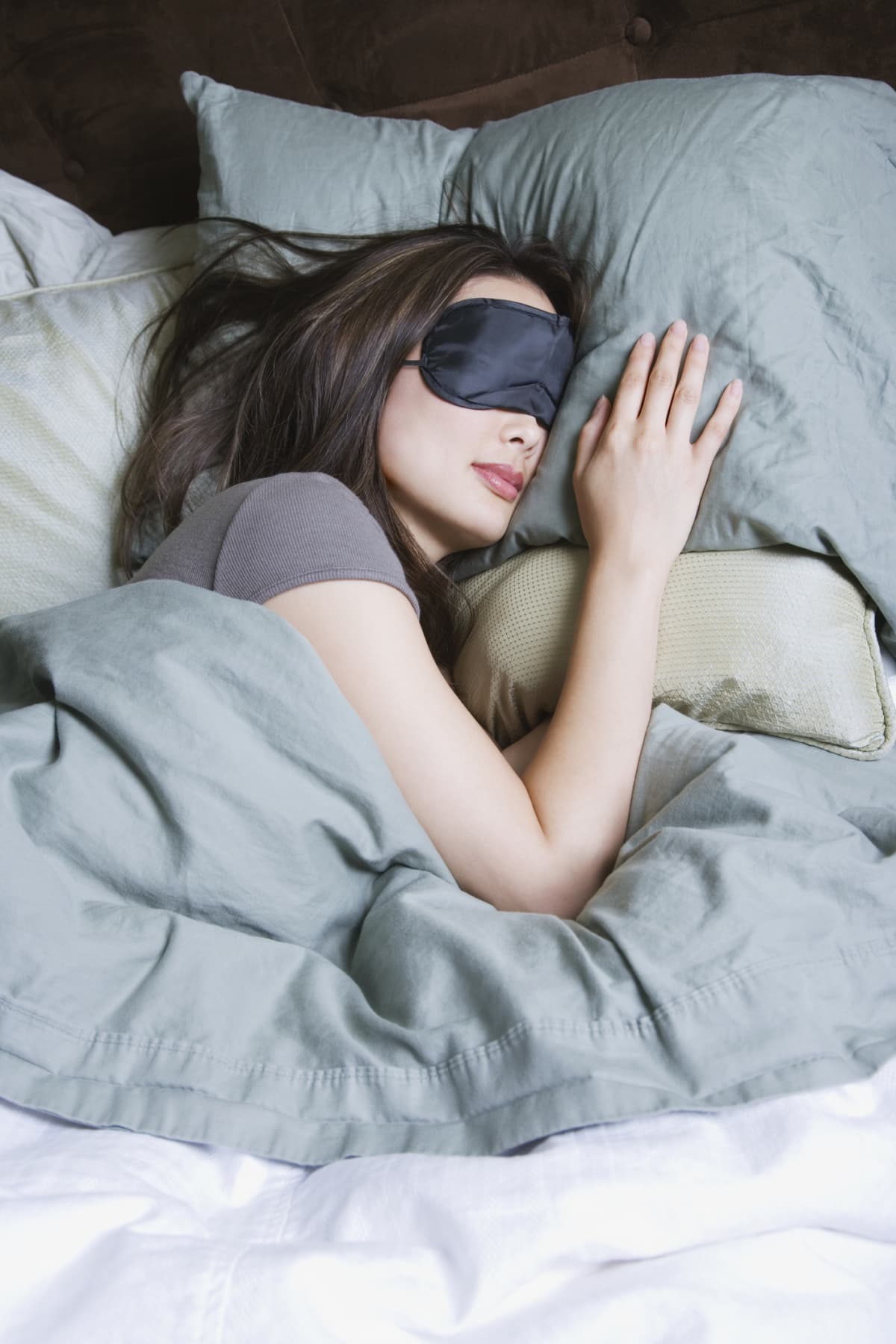 a woman sleeping with an eye sleep mask